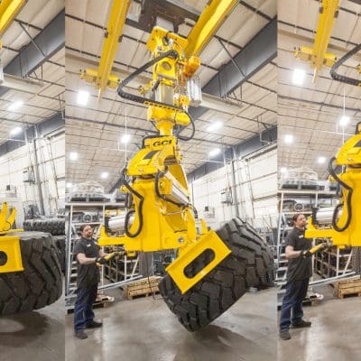 Overhead mount GCI manipulator lifting 3,000 lb Caterpillar tires of varying sizes