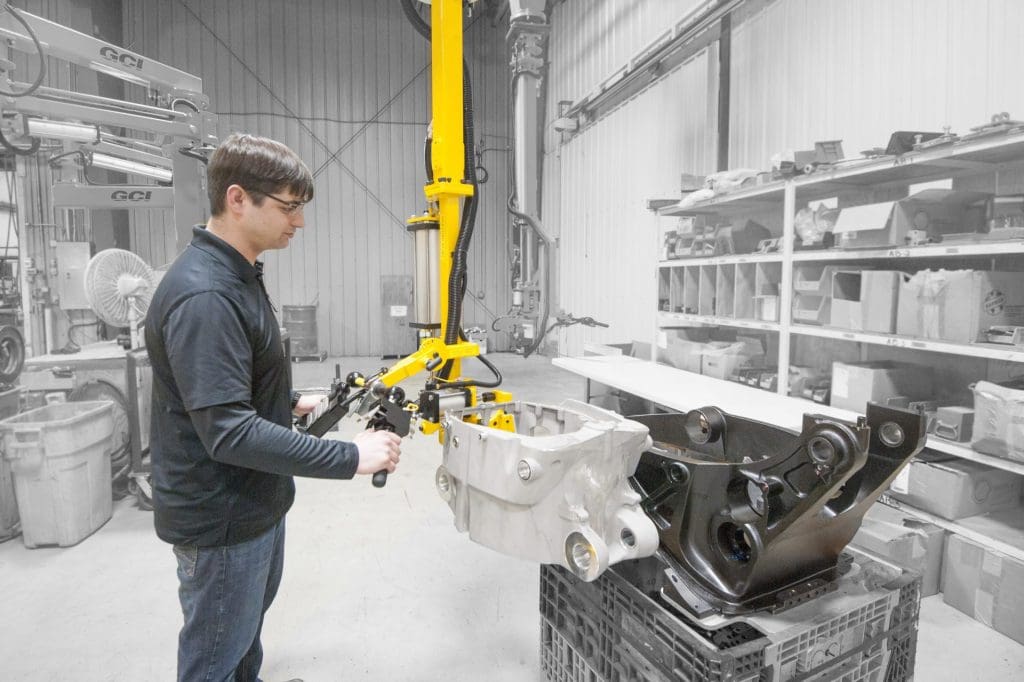 Operator lifts 60 lb engine casting with a GCI manipulator.