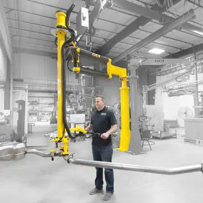 Operator lifts heavy exhaust with a GCI industrial manipulator arm