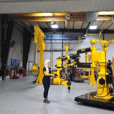 A woman operates a GCI torque reaction arm with a 3000 Nm tool
