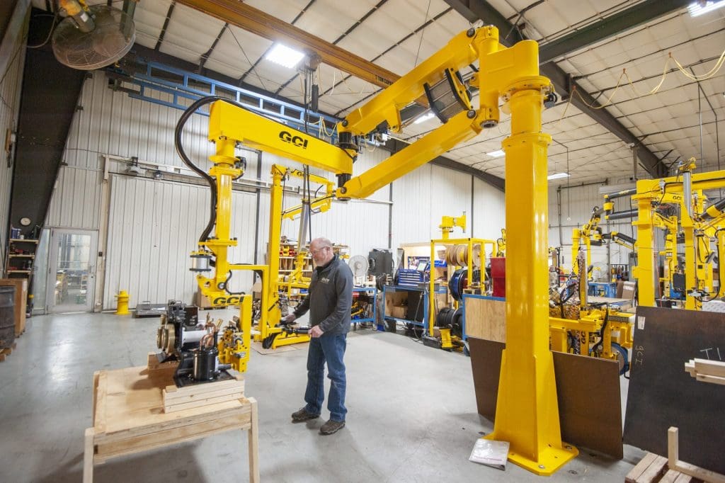 Operator lifts 250 lb refrigerator parts with a GCI industrial manipulator