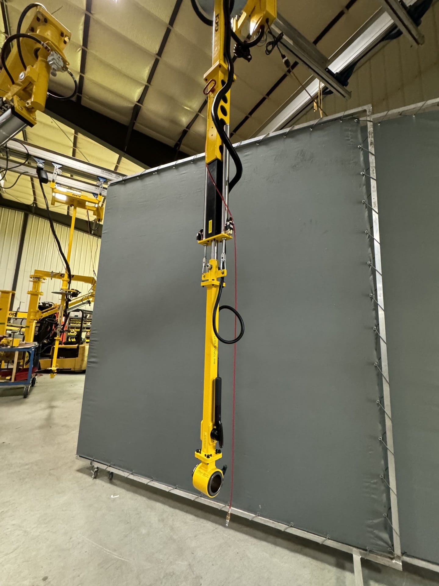 overhead mounted torque tube for automotive assembly