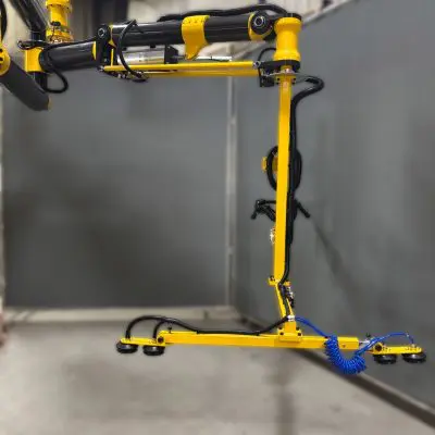 Carbon fiber manipulator arm with a vacuum cup gripper for sheet metal material handling process